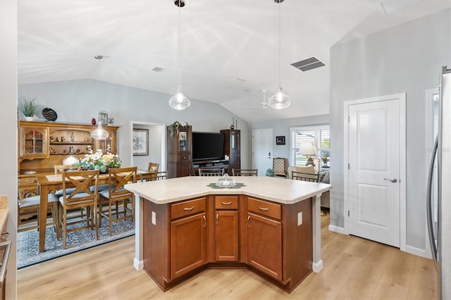 2188 Gordon Path, The Villages, FL 32163 - kitchen with light wood-type flooring, lofted ceiling, freestanding refrigerator, and light countertops