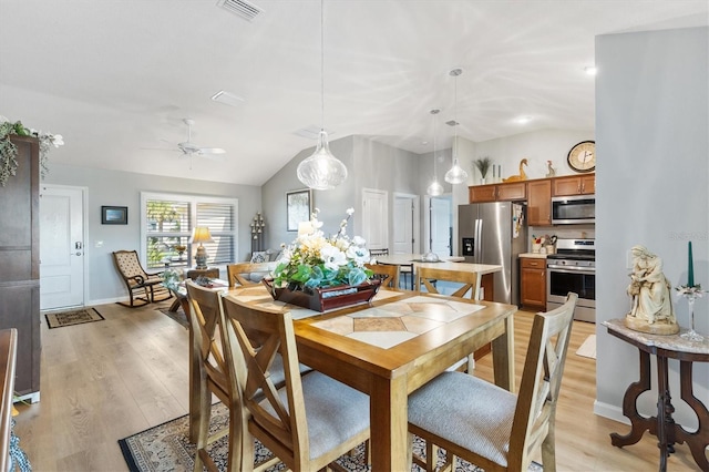2188 Gordon Path, The Villages, FL 32163 - dining space featuring light wood finished floors, visible vents, baseboards, vaulted ceiling, and a ceiling fan