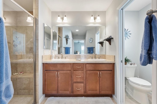 2188 Gordon Path, The Villages, FL 32163 - bathroom with double vanity, toilet, a stall shower, and a sink
