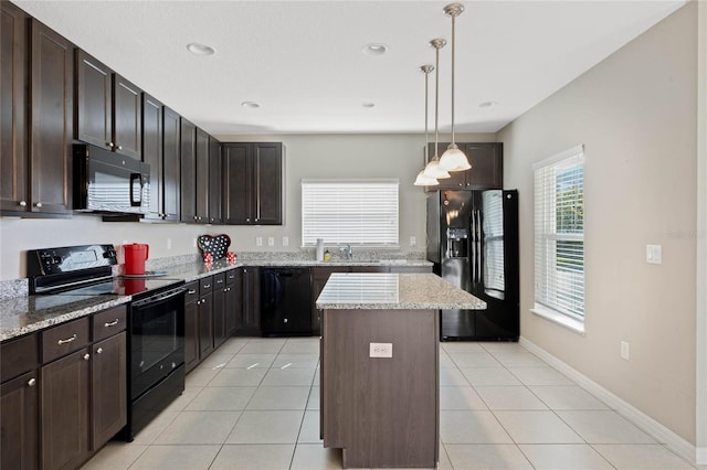 kitchen with light tile patterned floors, a sink, black appliances, decorative light fixtures, and a center island