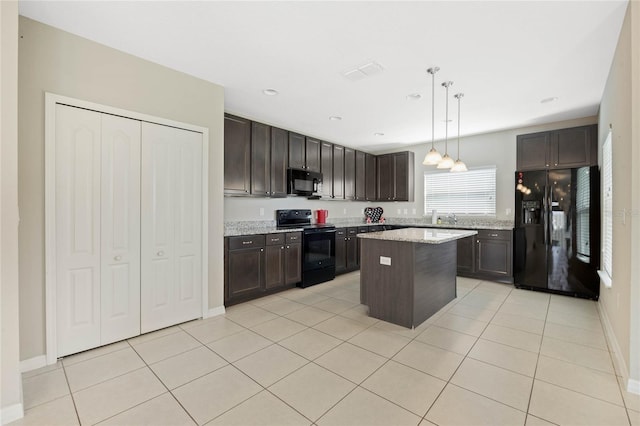 kitchen featuring light tile patterned floors, dark brown cabinets, black appliances, and decorative light fixtures