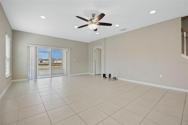 empty room with light tile patterned flooring, recessed lighting, and baseboards