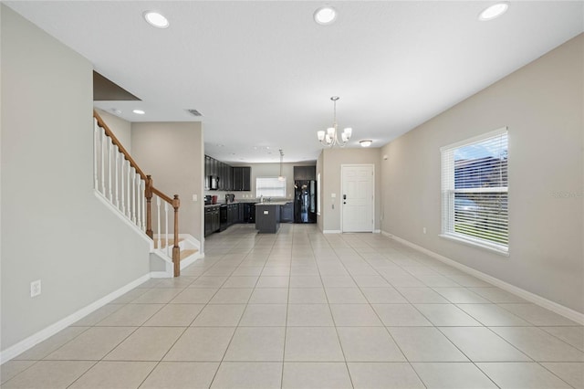 unfurnished living room with light tile patterned floors, baseboards, recessed lighting, and stairs