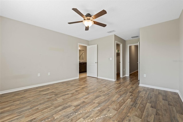 unfurnished bedroom featuring visible vents, ceiling fan, baseboards, and wood finished floors