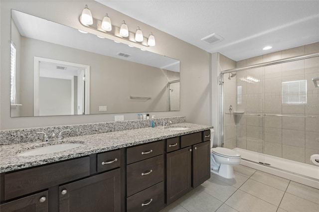 full bathroom with a sink, visible vents, a stall shower, and tile patterned flooring