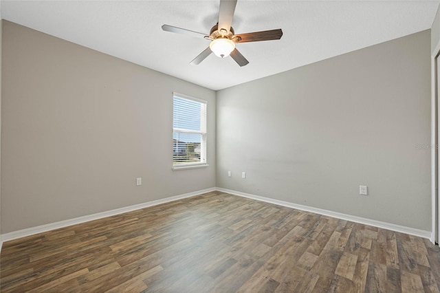 unfurnished room with a ceiling fan, wood finished floors, and baseboards