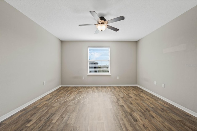 spare room with ceiling fan, baseboards, a textured ceiling, and wood finished floors