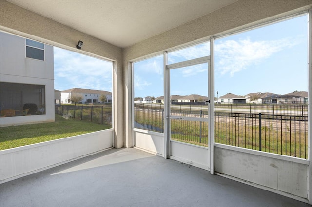 unfurnished sunroom with a residential view