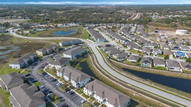 drone / aerial view with a residential view and a water view