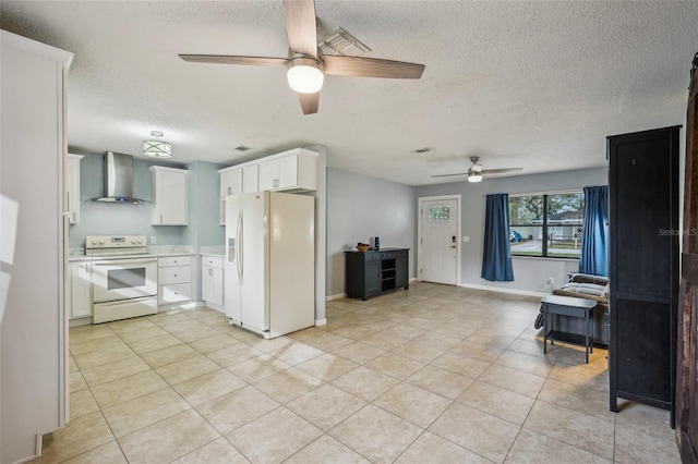 kitchen featuring open floor plan, white cabinetry, white appliances, light tile patterned flooring, and wall chimney exhaust hood