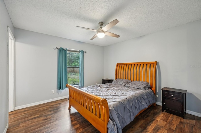 bedroom featuring a textured ceiling, baseboards, and wood finished floors