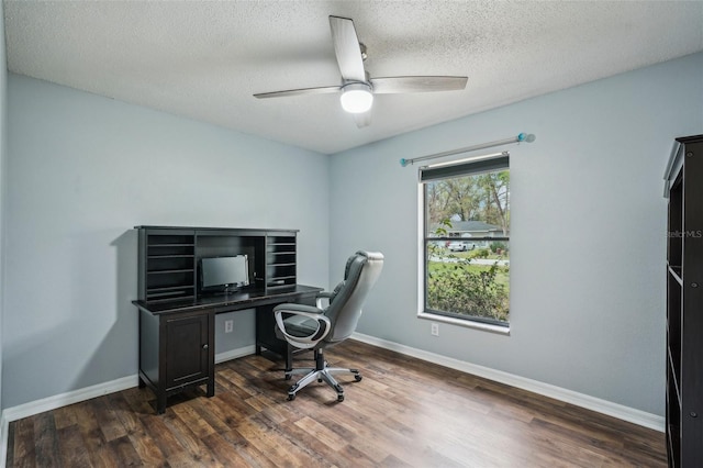 home office with a ceiling fan, dark wood-style floors, baseboards, and a textured ceiling