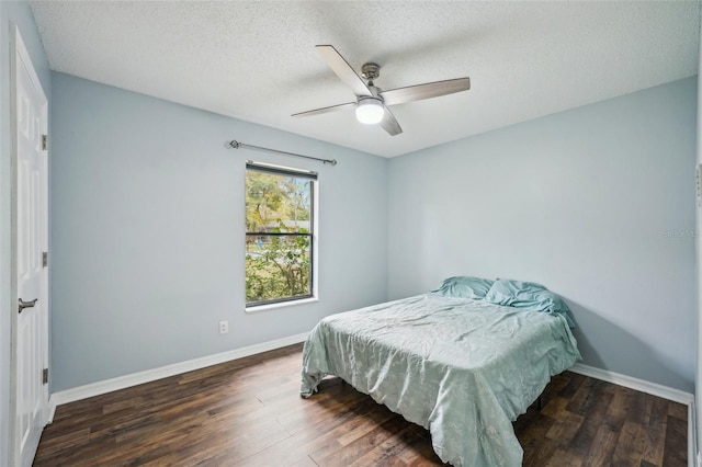 bedroom with ceiling fan, baseboards, a textured ceiling, and wood finished floors