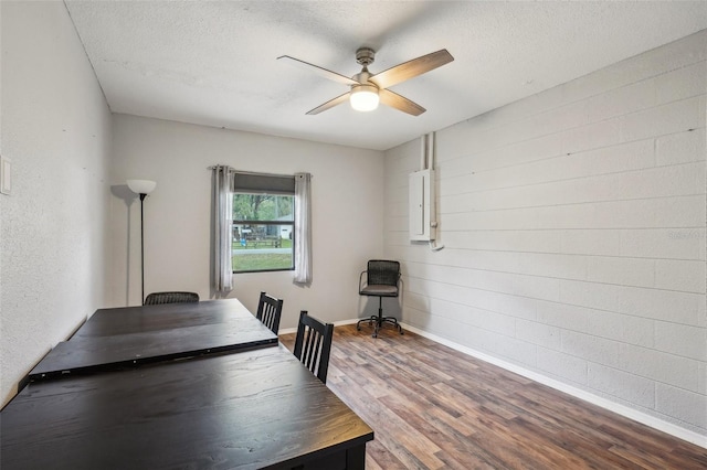 home office featuring ceiling fan, baseboards, a textured ceiling, and wood finished floors