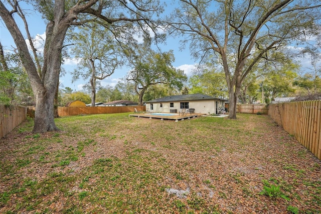 view of yard featuring a fenced backyard and a wooden deck