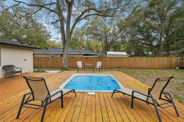 view of swimming pool with a deck, a fenced in pool, and a fenced backyard