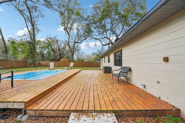 wooden terrace featuring a lawn and a fenced backyard