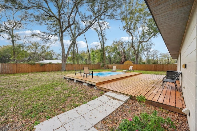 deck featuring a fenced backyard and a lawn