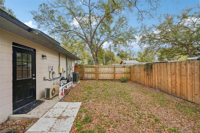 view of yard featuring central AC, a fenced backyard, and ac unit