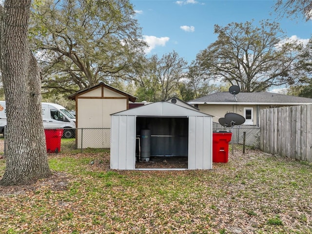 view of shed featuring fence