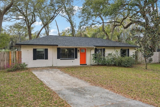 single story home featuring stucco siding, a front yard, and fence