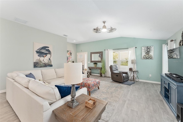 3786 Stephanie Way, The Villages, FL 32163 - living room featuring baseboards, light wood-style flooring, and vaulted ceiling
