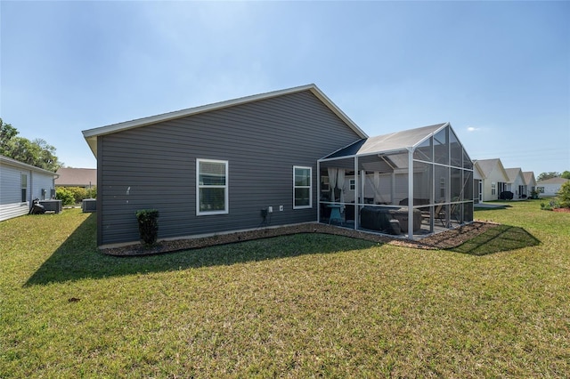 3786 Stephanie Way, The Villages, FL 32163 - back of property featuring glass enclosure, cooling unit, and a yard
