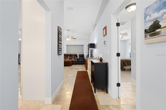 8880 SE 161st St, Summerfield, FL 34491 - corridor with baseboards, lofted ceiling, and stone finish floor