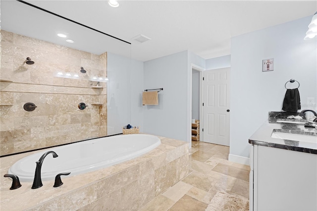 8880 SE 161st St, Summerfield, FL 34491 - bathroom with vanity, a garden tub, stone tile floors, and a tile shower