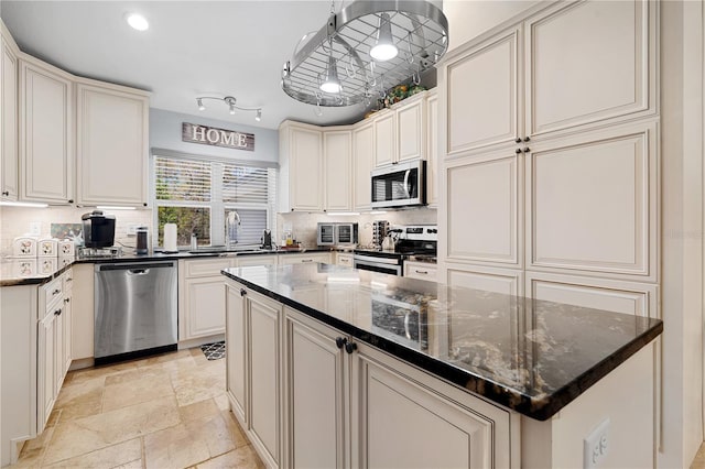 8880 SE 161st St, Summerfield, FL 34491 - kitchen featuring decorative backsplash, appliances with stainless steel finishes, a kitchen island, and a sink