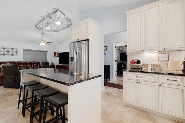 8880 SE 161st St, Summerfield, FL 34491 - kitchen featuring ceiling fan, open floor plan, stone tile floors, decorative backsplash, and stainless steel fridge