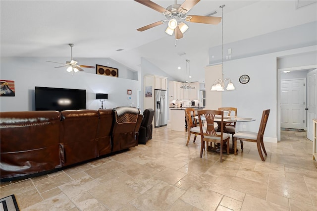 8880 SE 161st St, Summerfield, FL 34491 - living room with stone tile flooring, ceiling fan with notable chandelier, high vaulted ceiling, and baseboards