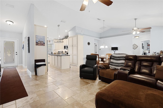 8880 SE 161st St, Summerfield, FL 34491 - living room featuring baseboards, stone tile flooring, a ceiling fan, and vaulted ceiling
