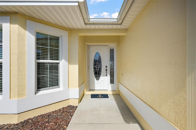 property entrance with stucco siding