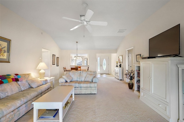 living room featuring visible vents, lofted ceiling, light colored carpet, and ceiling fan with notable chandelier