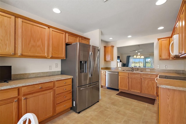 kitchen featuring recessed lighting, brown cabinets, appliances with stainless steel finishes, and a sink