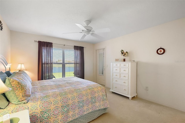 bedroom featuring light colored carpet and ceiling fan