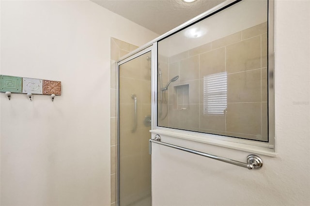 bathroom with tiled shower