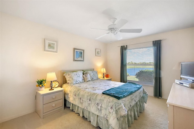 bedroom featuring a ceiling fan and light carpet