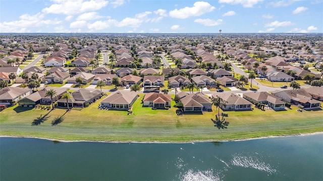 drone / aerial view with a residential view and a water view