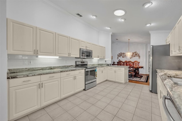kitchen with visible vents, ornamental molding, tasteful backsplash, appliances with stainless steel finishes, and vaulted ceiling
