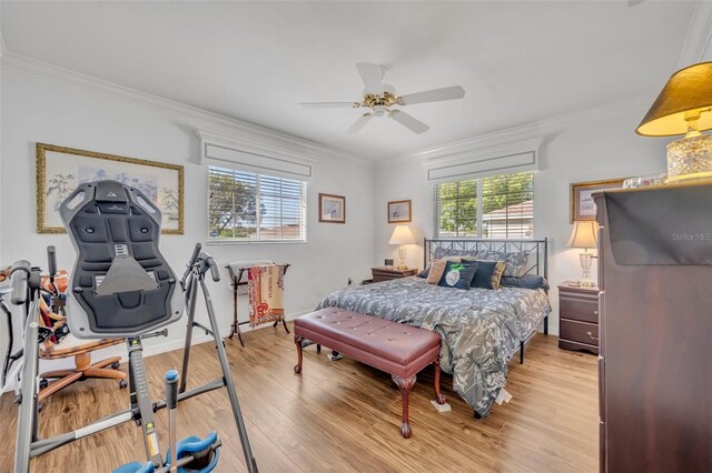 bedroom with baseboards, light wood-style floors, ornamental molding, and a ceiling fan