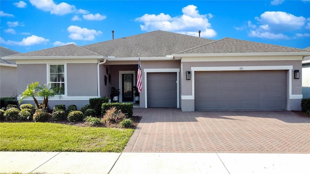 203 Silver Maple Rd, Groveland, FL 34736 - ranch-style house featuring stucco siding, decorative driveway, a garage, and a shingled roof