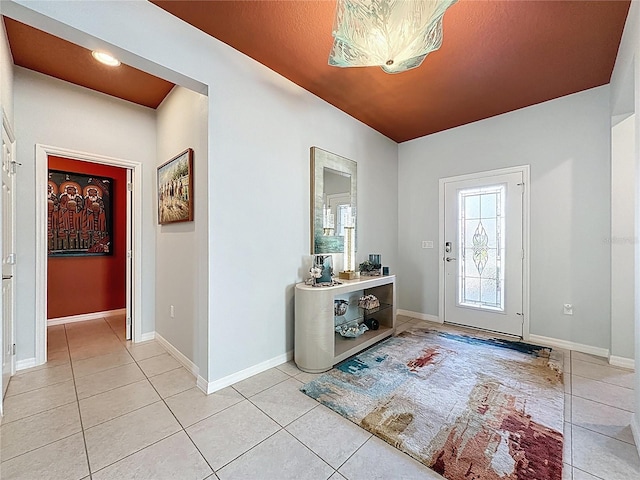 foyer with light tile patterned floors and baseboards