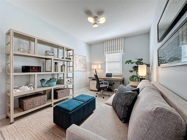 office space with tile patterned floors, baseboards, and a textured ceiling