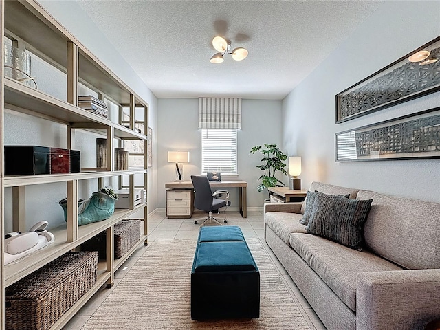 office space with tile patterned floors, a textured ceiling, and baseboards