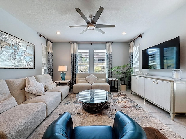 living area with light tile patterned floors, a textured ceiling, recessed lighting, and a ceiling fan