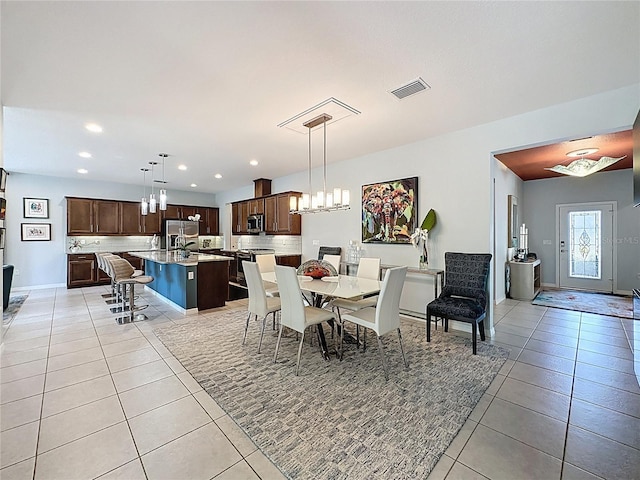 dining space featuring visible vents, recessed lighting, an inviting chandelier, light tile patterned floors, and baseboards