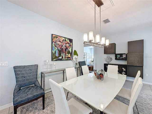 dining room with an inviting chandelier, light tile patterned floors, baseboards, and visible vents