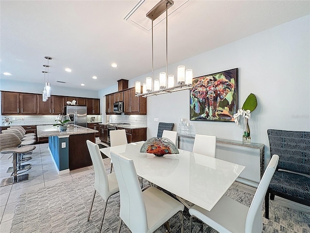 dining space featuring light tile patterned flooring and recessed lighting